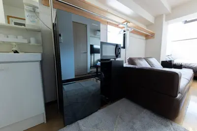 a bedroom with a bed and a tv and a mirror at shinjuku, tokyo city hall, apartment, Hotel for Max 6 person in Tokyo