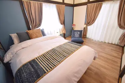 a bedroom with a large bed in front of a window at Shinozaki Kodate - Vacation STAY 16392 in Tokyo