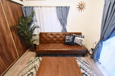 a brown leather couch sitting in a living room at Shinozaki Kodate - Vacation STAY 16392 in Tokyo