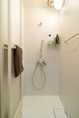 a shower with a glass door in a bathroom at 58, Higashi-Horikiri 2, private house rental, \u6771\u5800\u52072 in Tokyo