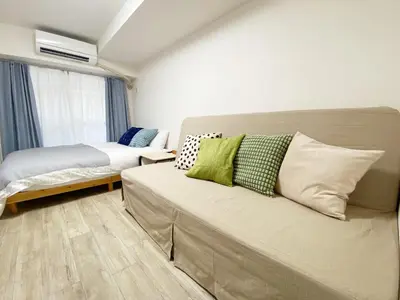 a living room with a couch and a bed at The Lions in Tokyo