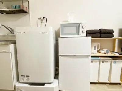 a kitchen with a refrigerator and a microwave at The Lions in Tokyo