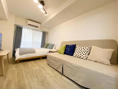 a living room with a couch and a bed at The Lions in Tokyo