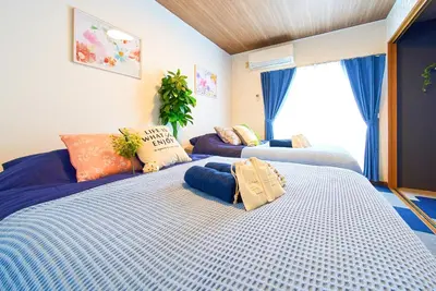 a bedroom with two beds with pillows on them at Shinjuku 102 Private Stay Near Park and Station with Free WiFi in Tokyo