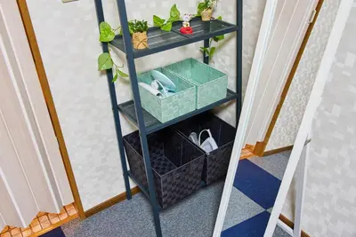 a ladder shelf with a basket and a box at Shinjuku 102 Private Stay Near Park and Station with Free WiFi in Tokyo