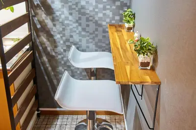 a small table with two white chairs and a table at Shinjuku 102 Private Stay Near Park and Station with Free WiFi in Tokyo