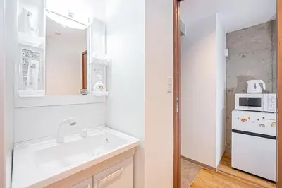 a white kitchen with a sink and a microwave at Zaito Tokyo East Mukojima APT in Tokyo