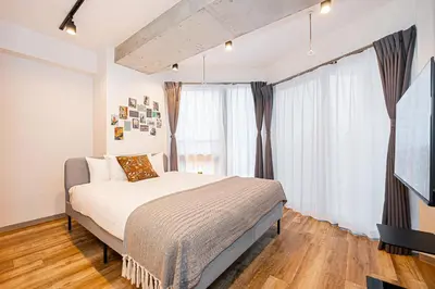 a bedroom with a bed and a large window at Zaito Tokyo East Mukojima APT in Tokyo
