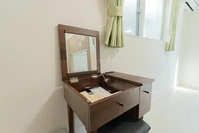 a bathroom with a wooden vanity with a mirror at \u732b\u597d\u304d i HOTEL SkyTree\u307e\u306714\u5206 \u6700\u592710\u4eba \u65b0\u7bc9 \u4e00\u6238\u8cb8 WiFi\u5b8c\u5099 \u6d17\u6fef\u4e7e\u71e5\u6a5f \u99d0\u8eca\u5834\u4e8c\u53f0\u5206 in Tokyo