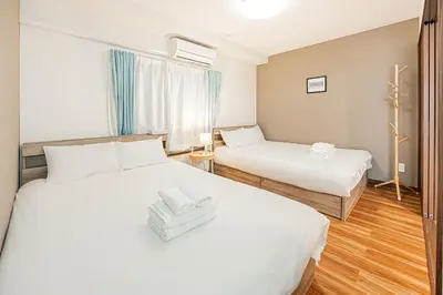 a hotel room with two beds and a window at self-check in-\u5927\u585a\u99c5One minute in Tokyo