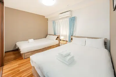 a hotel room with two beds and a window at self-check in-\u5927\u585a\u99c5One minute in Tokyo