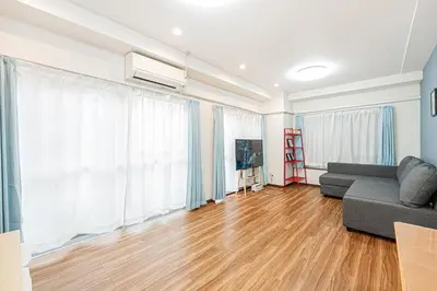 a living room with a couch and a television at self-check in-\u5927\u585a\u99c5One minute in Tokyo