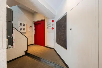 a hallway with a red door in a building at self-check in-\u5927\u585a\u99c5One minute in Tokyo