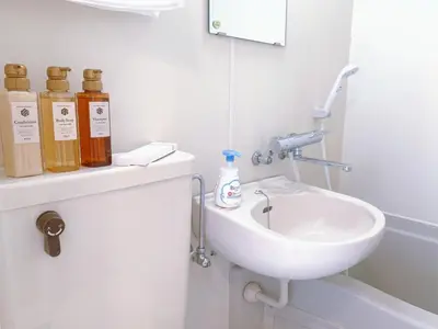 a white bathroom with a sink and a toilet at Amadeus 21 in Tokyo
