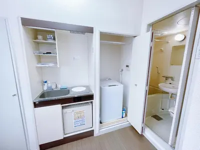 a small kitchen with a sink and a refrigerator at Amadeus 21 in Tokyo