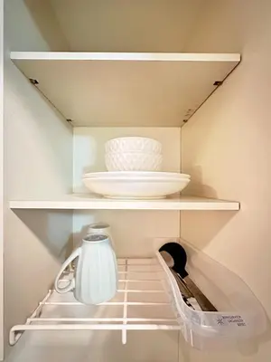 a white plate and a bowl on a shelf in a refrigerator at Amadeus 21 in Tokyo