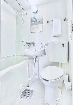 a white bathroom with a toilet and a sink at Amadeus 21 in Tokyo