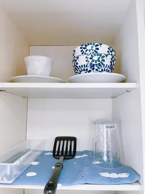 a shelf with plates and bowls and a spatula at Amadeus 21 in Tokyo