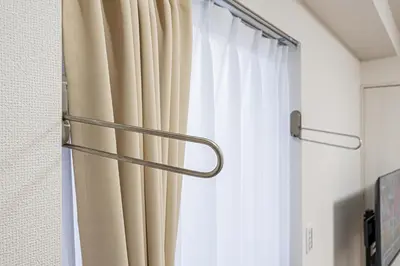 a curtain rod in a room with a window at ZAITO Tokyo PRETIC Hikifune in Tokyo