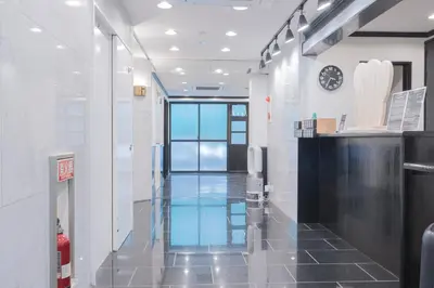 a hallway in a building with a clock on the wall at HOTEL TOKYO JOURNEY PORTAL KINSHICHO I Self Check-in Check-out Minutes from Sumiyoshi Station & Iconic Attractions & Sky Tree in Tokyo