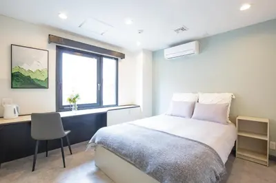 a bedroom with a bed and a desk and a window at HOTEL TOKYO JOURNEY PORTAL KINSHICHO I Self Check-in Check-out Minutes from Sumiyoshi Station & Iconic Attractions & Sky Tree in Tokyo
