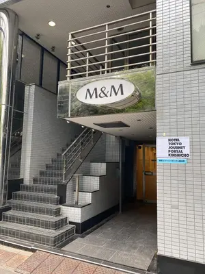 a mxmn sign on the side of a building with stairs at HOTEL TOKYO JOURNEY PORTAL KINSHICHO I Self Check-in Check-out Minutes from Sumiyoshi Station & Iconic Attractions & Sky Tree in Tokyo