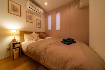 a bedroom with a bed with a black bag on it at 89, Yahiro 1, Detached House for Rent, \u516b\u5e831 in Tokyo