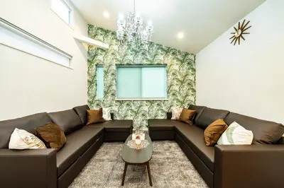 a living room with a brown couch and a window at 89, Yahiro 1, Detached House for Rent, \u516b\u5e831 in Tokyo