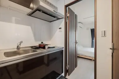 a small kitchen with a sink and a sink at self-check in-\u62bc\u4e0a Tokyo Skytree in Tokyo