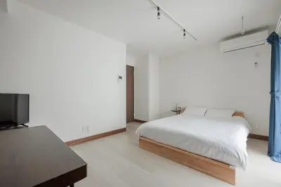 a bedroom with a bed and a flat screen tv at self-check in-\u62bc\u4e0a Tokyo Skytree in Tokyo