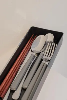 a black tray with silver utensils on a table at self-check in-\u62bc\u4e0a Tokyo Skytree in Tokyo