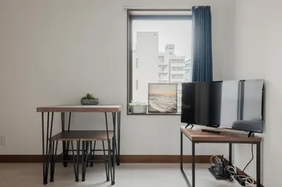 a television sitting on a table next to a window at self-check in-\u62bc\u4e0a Tokyo Skytree in Tokyo