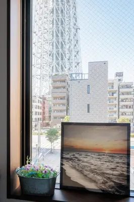 a window with a view of the eiffel tower at self-check in-\u62bc\u4e0a Tokyo Skytree in Tokyo
