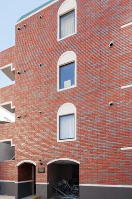 a red brick building with a parking garage at self-check in-\u62bc\u4e0a Tokyo Skytree in Tokyo
