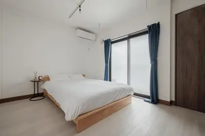 a bedroom with a bed and a large window at self-check in-\u62bc\u4e0a Tokyo Skytree in Tokyo