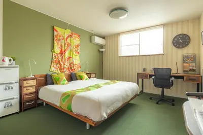 a bedroom with a bed and a desk and a chair at The Ivy Apartments, BEST Location, Yoyogi!! in Tokyo