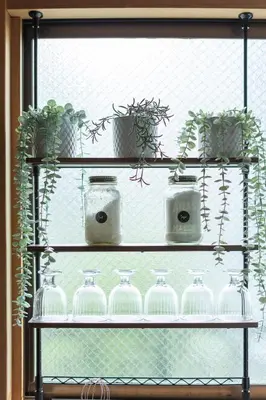 a shelf with glass bottles and potted plants on it at The Ivy Apartments, BEST Location, Yoyogi!! in Tokyo