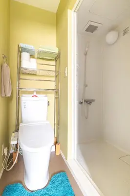 a bathroom with a white toilet and a shower at The Ivy Apartments, BEST Location, Yoyogi!! in Tokyo