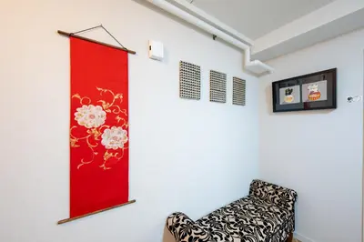 a room with a chair and a red banner on the wall at chano-ma in Tokyo
