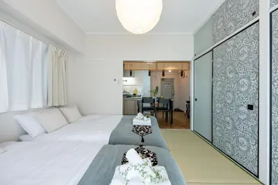 a bedroom with two beds and a living room at chano-ma in Tokyo