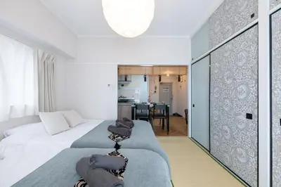 a bedroom with a bed and a living room at chano-ma in Tokyo
