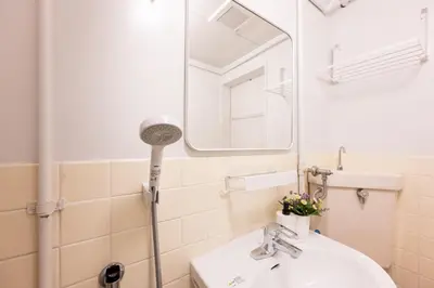 a bathroom with a sink and a mirror at chano-ma in Tokyo