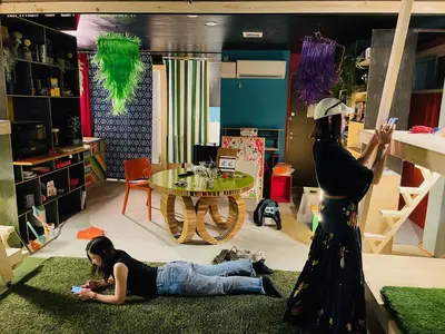 two women laying on the floor in a living room at Lab8 Tokyo - Creative Coliving & Group Stay 6 Minutes to Shibuya Stay Play & Connect in Tokyo