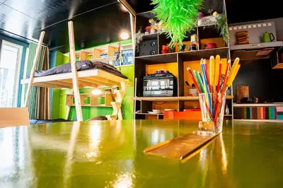 a table with a vase of colored pencils on it at Lab8 Tokyo - Creative Coliving & Group Stay 6 Minutes to Shibuya Stay Play & Connect in Tokyo