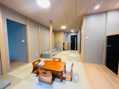a room with a table and chairs and a bed at \u65b0\u5bbf6 Home in Tokyo