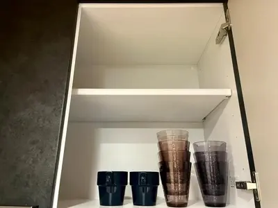a white shelf with four cups on it at \u65b0\u5bbf6 Home in Tokyo