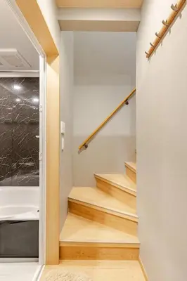 a staircase in a house with wooden floors at \u65b0\u5bbf6 Home in Tokyo