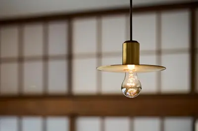 a light bulb hanging from a ceiling at Pufuka Wakakusa \u3077\u3075\u304b\u82e5\u8349 in Tokyo