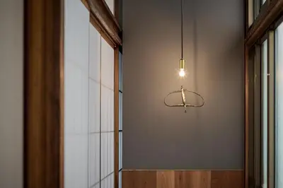 a light fixture hanging from a wall next to a window at Pufuka Wakakusa \u3077\u3075\u304b\u82e5\u8349 in Tokyo