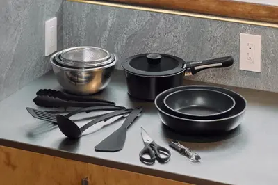 a kitchen counter with utensils on a counter top at Pufuka Wakakusa \u3077\u3075\u304b\u82e5\u8349 in Tokyo